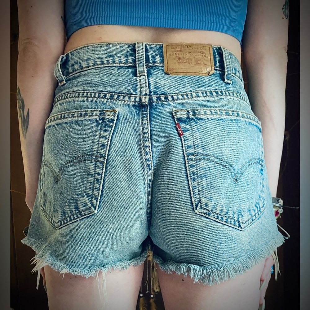Vintage 90’s Levi’s 550 medium wash denim cut off shorts